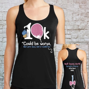 May include: Black tank top with a graphic featuring the text "10k" with a pink glitter balloon and the phrase "Could be worse." The back of the tank top has text that reads "Walt Disney World Springtime Surprise 6.2m Race 2026."