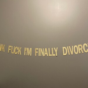 May include: Gold glitter banner with the text "THANK FUCK I'M FINALLY DIVORCED".