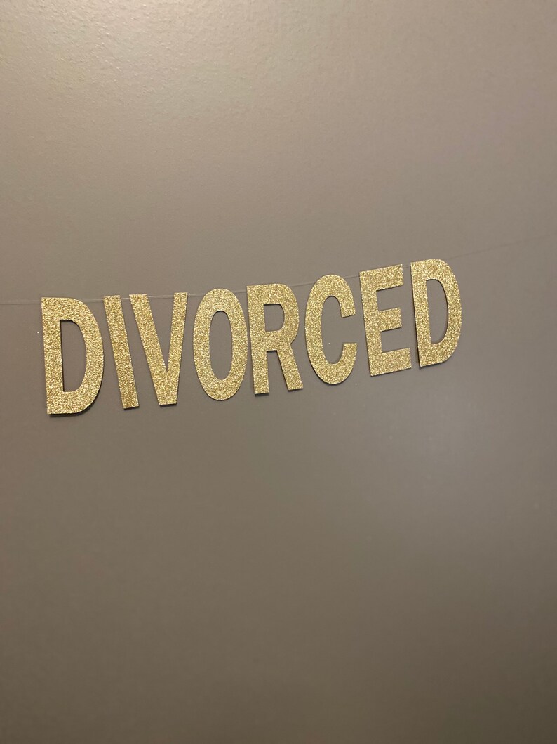 May include: A gold glitter banner with the word "DIVORCED" spelled out.