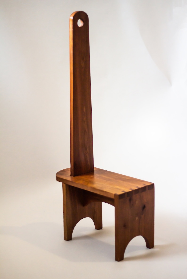 May include: A wooden step stool with a tall back and a handle at the top. The stool is made of solid wood and has a natural finish.