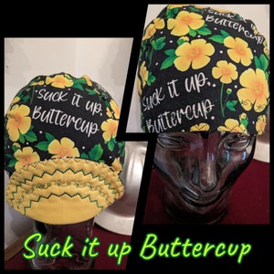 May include: Black scrub hat with a yellow floral pattern and the text "Suck it up, Buttercup".