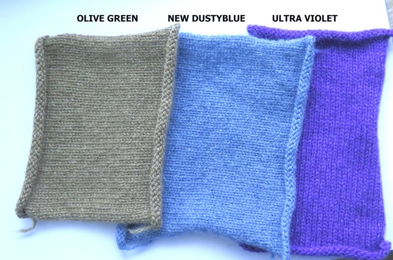 May include: Three knitted fabric swatches in olive green, dusty blue, and ultra violet.