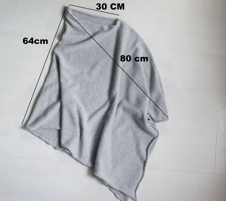 May include: A gray knitted poncho with a 30-inch neck opening, 64-inch length, and 80-inch width.
