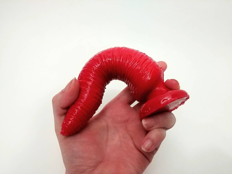 bendy devil dildo with hand for scale 