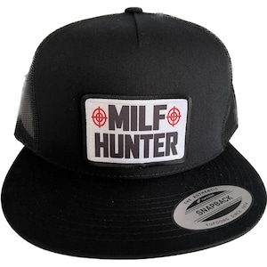 May include: Black trucker hat with a white patch that says "MILF HUNTER" with red target symbols on either side of the word "MILF". The hat has a black mesh back and a black snap closure.