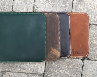May include: Four leather mousepads in different colors: green, brown, black, and brown. The brown mousepad has the text "Cogliano Leatherworks" on it.
