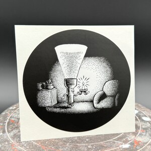 May include: A black and white illustration of a torch with a face, shining its light on a small candle holder with two candles. The torch is standing next to a small table with a potted plant on top. There is a chair in the background.