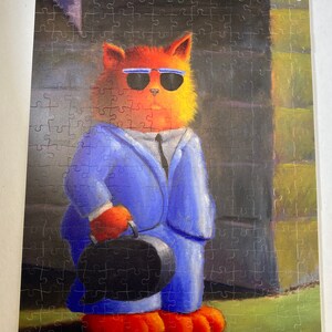 May include: A cartoon cat wearing a blue suit and sunglasses, holding a black briefcase. The cat is standing in front of a brick wall.