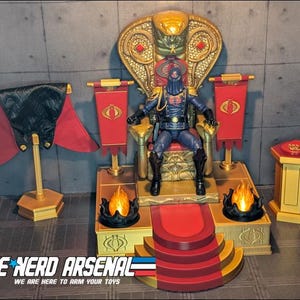 Può includere: Un action figure di Cobra Commander seduto su un trono dorato con schienale a forma di cobra. Il set include un mantello rosso su supporto, due stendardi rossi con loghi Cobra, due basi con effetto fuoco nero e un piedistallo dorato con cuscino.