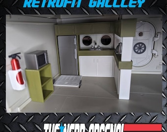 May include: A miniature model of a galley kitchen from the U.S.S. Flagg, a fictional aircraft carrier from the G.I. Joe toy line. The galley features a white refrigerator, a microwave, a sink, and cabinets. The galley is painted in a green and white color scheme.