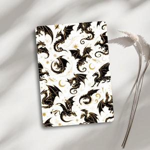 May include: A rectangular card featuring a repeating pattern of black dragon silhouettes on a white background. The design includes gold-coloured stars and crescent moons interspersed among the dragons, which are depicted in various flying poses.