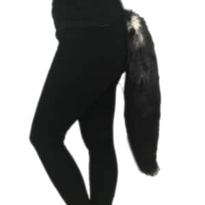 May include: A black and white faux fur tail with a black elastic band for attaching to clothing.