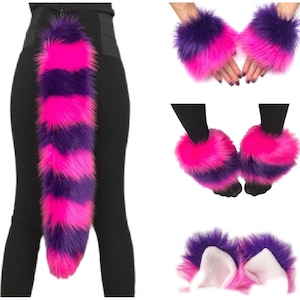 May include: A set of faux fur accessories featuring a long tail, wrist cuffs, leg warmers, and ear headbands. Each piece is crafted from long, shaggy synthetic fur with alternating horizontal stripes of vibrant hot pink and deep purple.