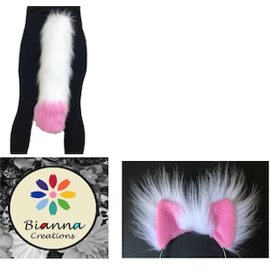 May include: White and pink fluffy tail with a pink tip. The tail is attached to black leggings. The tail is a costume accessory.
