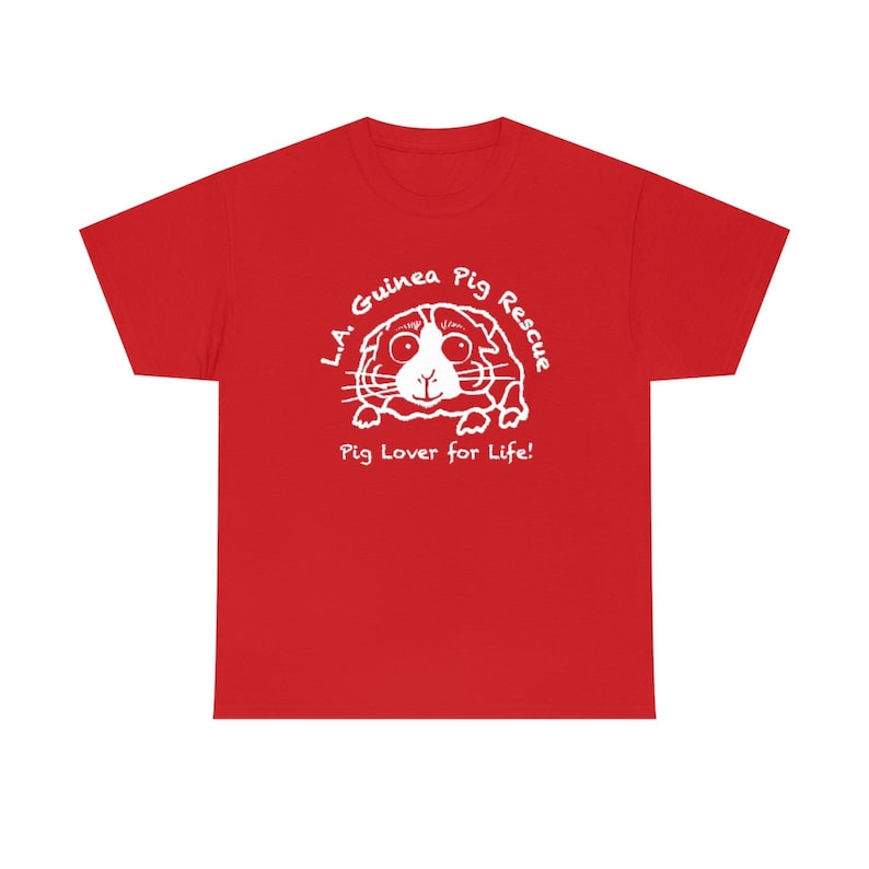 May include: A red t-shirt featuring a white graphic of a guinea pig with the text "L.A. Guinea Pig Rescue" and "Pig Lover for Life!". The design is centered on the front of the shirt.