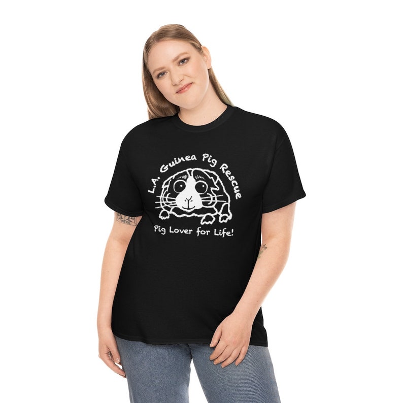 May include: Black t-shirt with a white graphic of a guinea pig and the text "L.A. Guinea Pig Rescue" and "Pig Lover for Life!". The shirt is made of a soft material and has short sleeves.