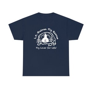 May include: Navy blue t-shirt featuring a white graphic of a guinea pig with the text "L.A. Guinea Pig Rescue" and "Pig Lover for Life!". The design is centered on the front of the shirt, creating a simple yet eye-catching design.