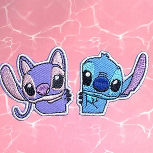May include: Two embroidered iron-on patches featuring Stitch and Angel from the Disney movie Lilo & Stitch. Stitch is blue with a purple ear and Angel is purple with a pink ear.