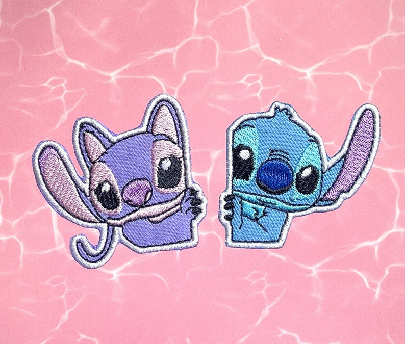 May include: Two embroidered iron-on patches featuring Stitch from the Disney movie Lilo & Stitch. One patch is blue and the other is purple.