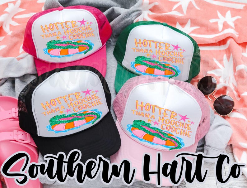 May include: Four trucker hats in pink, black, green, and light pink. Each hat has a white front panel with the text "HOTTER THAN A HOOCHIE COOCHIE" and a graphic of a pool float. The hats are on a patterned background.