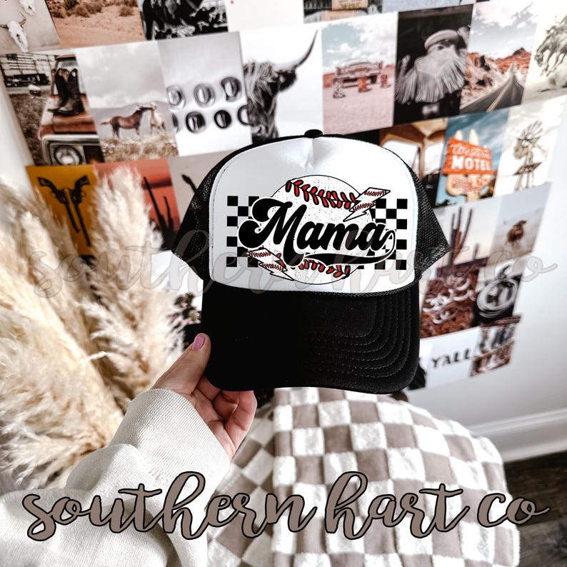 May include: Black and white trucker hat with a white baseball graphic and the word "Mama" in a retro font. The hat has a black mesh back.