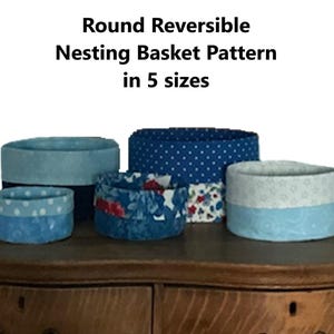 May include: Five round, reversible nesting baskets in various shades of blue and patterned fabrics. The text at the top reads "Round Reversible Nesting Basket Pattern in 5 sizes."