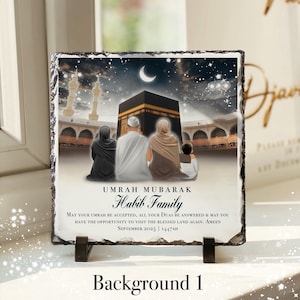 May include: A square stone tile featuring a printed image of a family at the Kaaba in Mecca. The image includes the text "Umrah Mubarak Habib Family" and a message wishing for acceptance and blessings. The tile is displayed on a black stand.