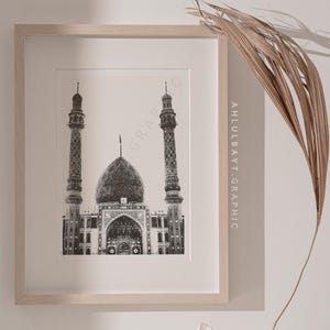 May include: A black and white illustration of a mosque with two minarets. The mosque is framed in a light wood frame. The text "AHLULBAYT.GRAPHIC" is printed on the right side of the frame.
