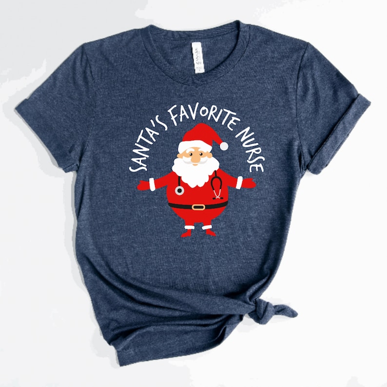 May include: A navy blue t-shirt with a white graphic of Santa Claus wearing a stethoscope and the text "Santa's Favourite Nurse".