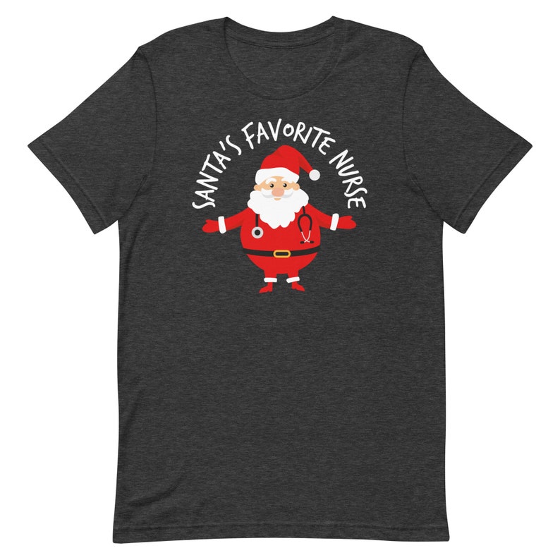 May include: Dark heather grey t-shirt featuring a cartoon Santa Claus wearing a stethoscope and the text "Santa's Favourite Nurse".