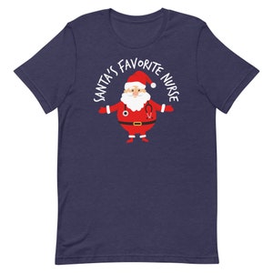 May include: A navy blue t-shirt featuring a white graphic of Santa Claus wearing a stethoscope and the text "Santa's Favourite Nurse".