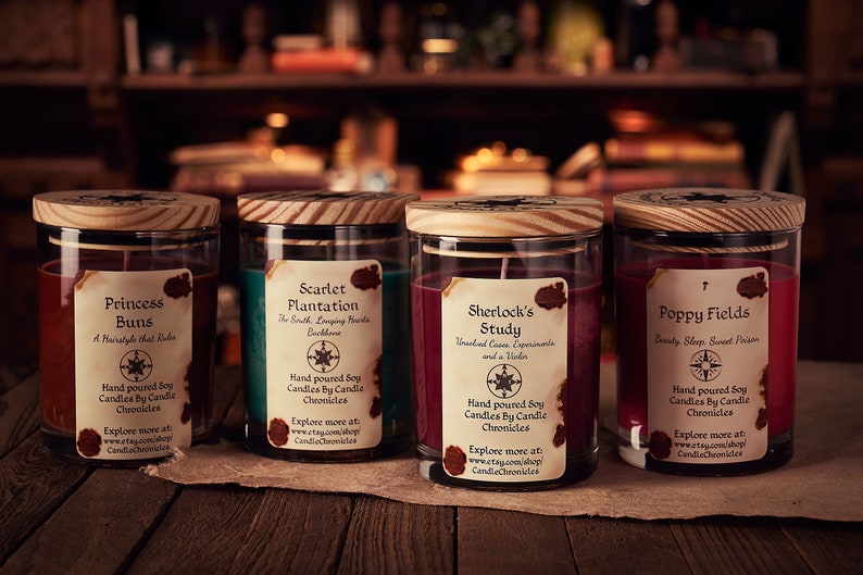 May include: Four glass jar candles with wooden lids, each labeled with a unique name: "Princess Buns," "Scarlet Plantation," "Sherlock's Study," and "Poppy Fields." The labels include descriptions and the Etsy shop name, CandleChronicles.