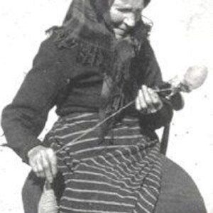 May include: A woman wearing a headscarf and a striped skirt spins yarn with a spinning wheel.