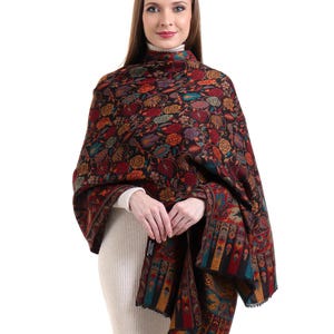 May include: A black shawl with a colorful floral pattern. The shawl is made of a soft, warm material and is perfect for keeping you warm in the winter.