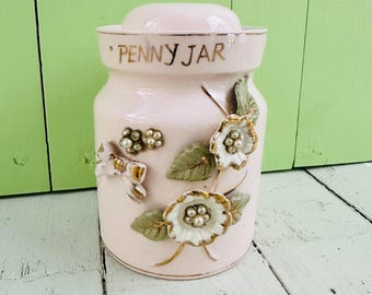 Hucha vintage de mediados de siglo, rara, tipo "tarro de monedas", Tilco Japón, flores rosas, cuentas y cintas.