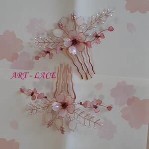 May include: Two hair combs featuring rose gold wire branches adorned with translucent pink and white resin flower petals, small white beads, and metallic pink seed beads. The text ART-LACE is printed in pink on the left side of the image.