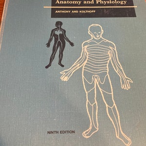 May include: A textbook titled "Textbook of Anatomy and Physiology" by Anthony and Kolthoff. The cover is light blue with a black and white illustration of the human body. The ninth edition is printed at the bottom.