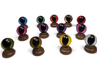 May include: Assortment of colorful plastic googly eyes with black pupils, mounted on brown plastic bases.