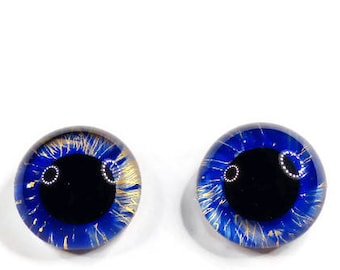 May include: A pair of blue glass eyes with gold flecks and black pupils. These eyes are perfect for adding a realistic touch to your craft projects.