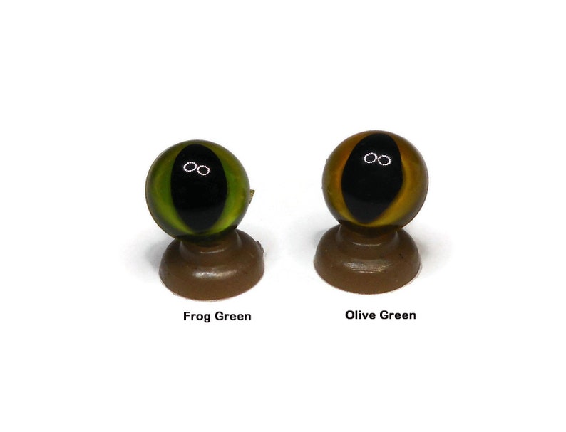 May include: Two plastic animal eyes, one is frog green and the other is olive green. Both eyes have black pupils.