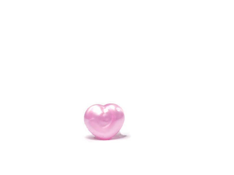 May include: A single pink heart-shaped bead.