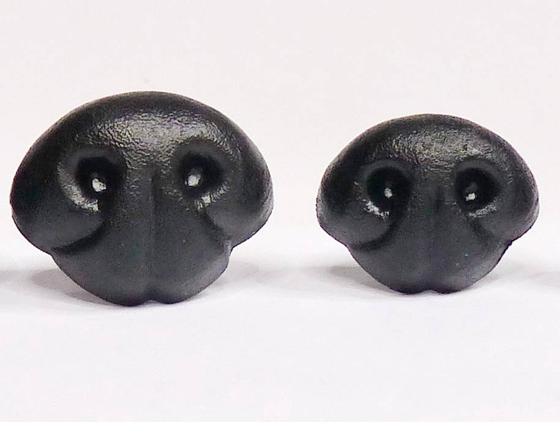 May include: Two black plastic animal noses, one larger than the other. Both have two holes for nostrils.