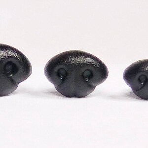 May include: Three black plastic animal noses of different sizes. The noses have two small holes for nostrils.
