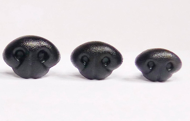 May include: Three black plastic animal noses of different sizes. The noses have two small holes for nostrils.