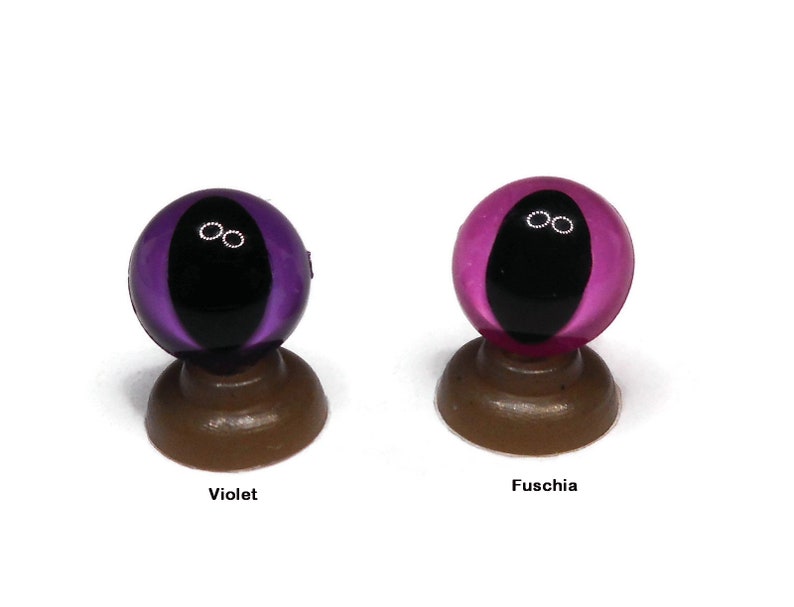 May include: Two glass eyes with black pupils and white irises. The eye on the left is violet and the eye on the right is fuchsia.