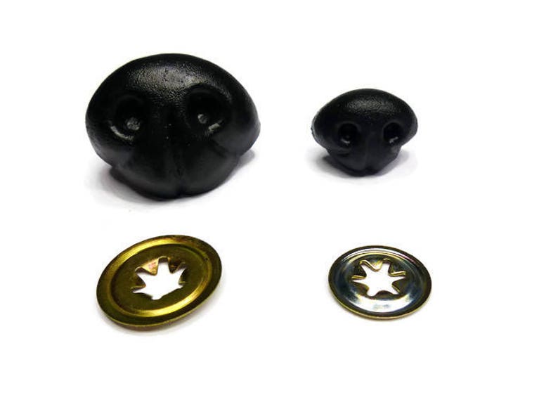 May include: Two black plastic animal noses, one larger than the other, and two metal washers with a star-shaped cut-out.
