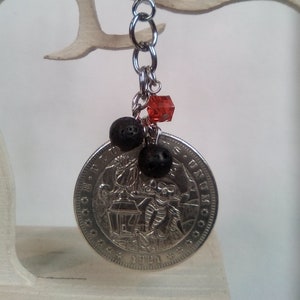 Key ring replica of a 1 Dollar USA Morgan coin with pirate lantern motif.