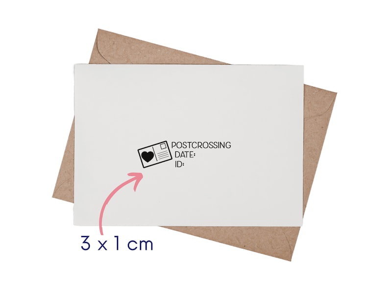 May include: A white rectangular card placed on a brown envelope. The card features a black ink stamp design of a postcard with a heart icon, the text POSTCROSSING, DATE:, and ID:. A pink arrow points to the stamp with the text 3 x 1 cm.