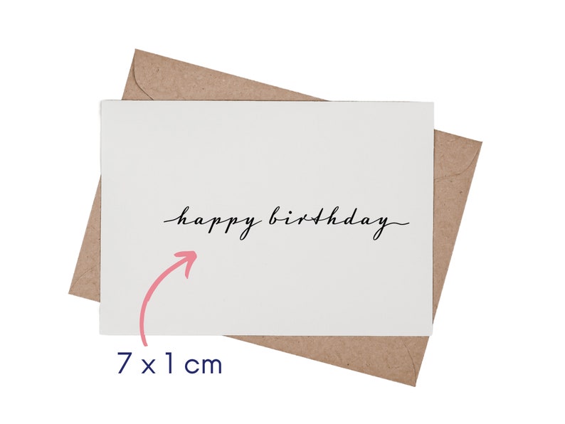 May include: A white greeting card with the black cursive text happy birthday centered on the front, placed over a brown kraft paper envelope. A pink arrow points to the text, accompanied by the measurement text 7 x 1 cm.