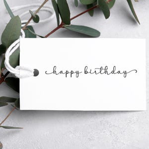 May include: A white gift tag with a black handwritten message that says "happy birthday".